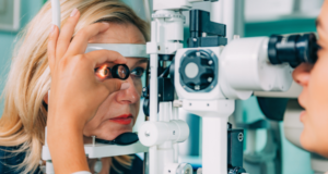 The Role of Optometrists in Detecting Systemic Diseases Woman undergoing an eye exam at the optometrist.
