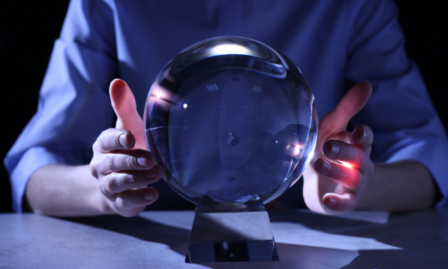 crystal ball with hands on either side