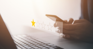 A Bad Review Is Not a Verdict. 5 Key Steps To Handling Online Reviews in Optometry person on phone leaving a one-start review