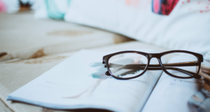 Optometry 411 Top Stories of the Year glasses on top of an open magazine
