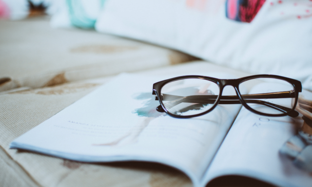 glasses on top of an open magazine