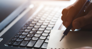 CE for Optometrists: Your 2024 Guide to Earning Credits Before the Year Ends close up of a laptop keyboard and notebook