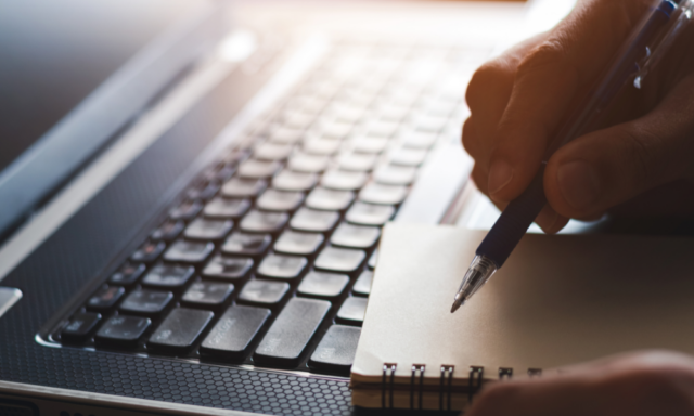 close up of a laptop keyboard and notebook