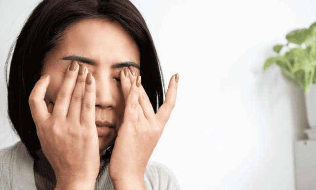 woman rubbing her eyes