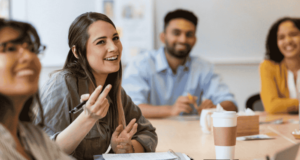 Genius Idea: Try This Successful Team-Building Reward System in Your Optometry Practice Staff members sitting around a table smiling