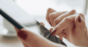 What Online Contact Lens Shopping Trends Mean for Your Optometry Practice woman's hands holding a phone