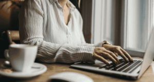 April 5 – 6 | CEwire2025 woman at a laptop with a cup of tea at her side