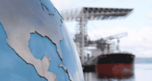 Tariff Breakdown for ODs: What’s Happening, What It Means, and What You Can Do globe in foreground with freight ships in background