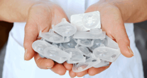 Sustainable Eyecare Starts Here: A New Resource for Environmentally Minded ODs Just Dropped cupped hands overflowing with contact lens blister packs