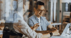 Rethinking Competition in Optometry Two work colleagues collaborating at a table