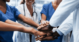 Integrated Care Is the Goal — Here’s What’s Getting in the Way A group of healthcare professionals stacking hands