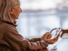 AOA Revises Telemedicine in Optometry Policy Woman using smartphone for a telehealth appointment