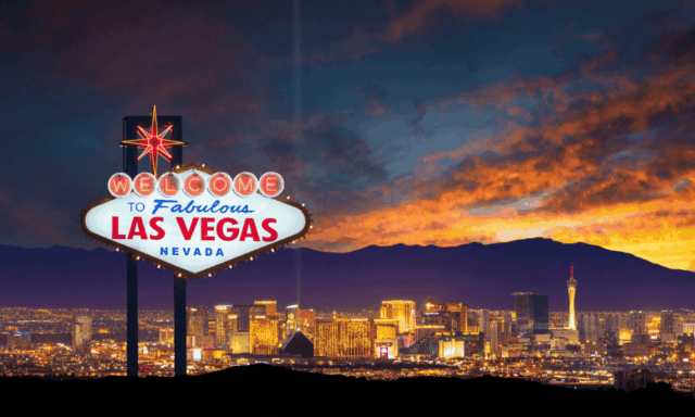 Las Vegas sign at sunset with skyline in background