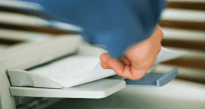 The Essential One-Pager Every OD Should Have hand grabbing paper out of a fax machine tray