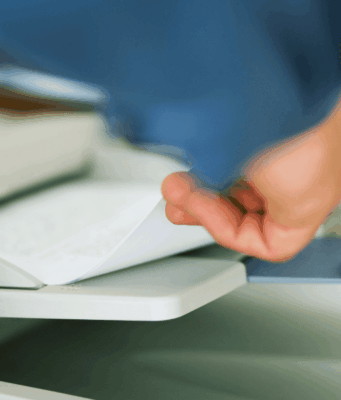 The Essential One-Pager Every OD Should Have hand grabbing paper out of a fax machine tray