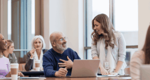 Last Call for CE Hours: In-Person and On-Demand Events To Close Out 2025 People sitting at tables at a conference presentation