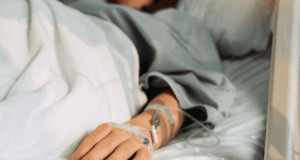 The ‘What If I’m Out Sick?’ Test for Practice Continuity View of the hand of a person in a hospital bed, hooked up to an IV