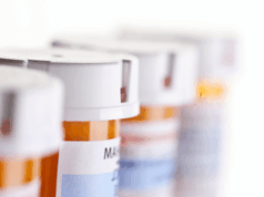 New Law Eases DEA Training Requirements for Optometrists a row of prescription pill bottles