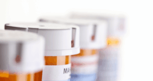 New Law Eases DEA Training Requirements for Optometrists a row of prescription pill bottles