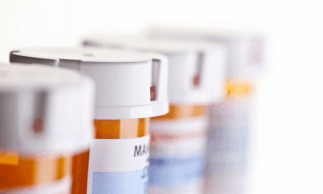 a row of prescription pill bottles