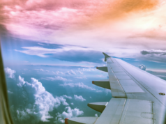 How To Take Time Off Without Paying for It Later view of clouds from an airplane window