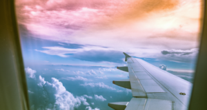 How To Take Time Off Without Paying for It Later view of clouds from an airplane window