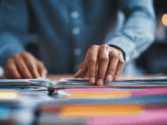 A New Way To Find Evidence-Based Optometric Guidelines hands flipping through stacks of files